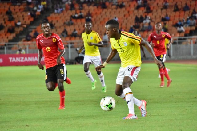 Rogers Mugisha (R) in action against Angola on Sunday