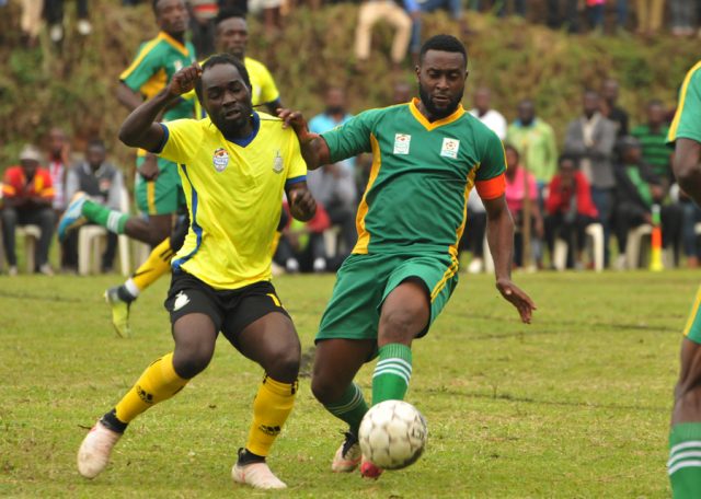 Kampala Province Striker Daniel Serunkuma (L) battling with Tooro United captain Timothy Musinguzi