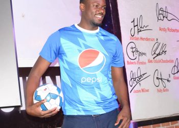 Pepsi Brand Manager, Ernest Ssentongo poses for a photo moment after a press briefing.
