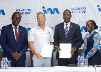 I&M Bank Acting Managing Director Sam Ntulume (2R) and Serena's Theo Van Rooyen (2L) display the MOU after the presser on Tuesday as Annette Nakiyaga (R), I&M Bank Head of Marketing & Corporate Communication and Edward Gibson Nangono (L) who is the Chief Business Officer at I&M Bank look on.