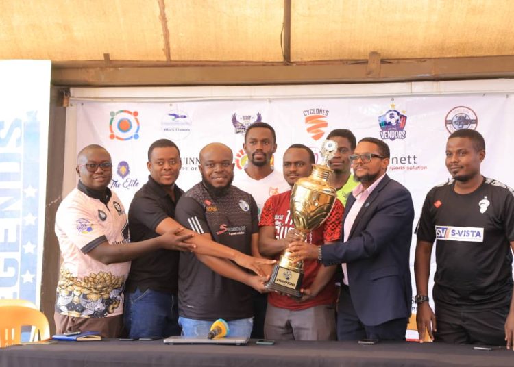 SMACK League organizers and a section of team representatives pose with a trophy that will be competed for in the new season.