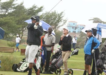Golfer Innocent Nahabwe (front) and other players watch his ball after teeing at a previous event at Lake Victoria Serena Golf Resort and Spa's course in Kigo. He's one of the golfers playing at the Serena 63 Golf Series